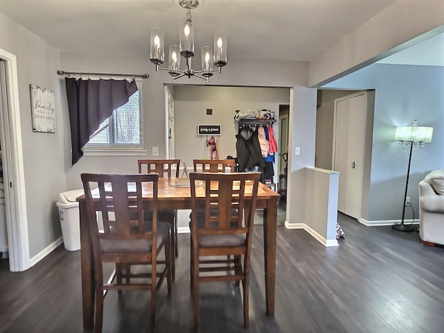 dining room with a notable chandelier and dark hardwood / wood-style floors