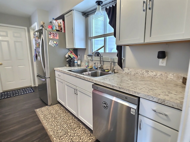 kitchen featuring white cabinetry, sink, dark hardwood / wood-style flooring, and appliances with stainless steel finishes