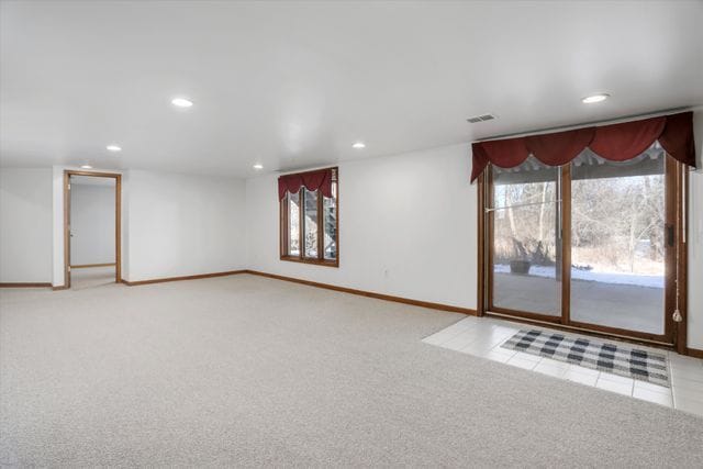 unfurnished room featuring light carpet