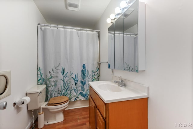 bathroom featuring vanity, hardwood / wood-style flooring, a shower with curtain, and toilet