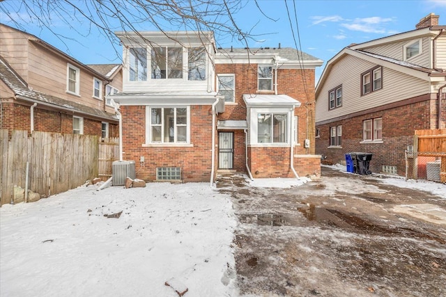 snow covered property featuring central air condition unit