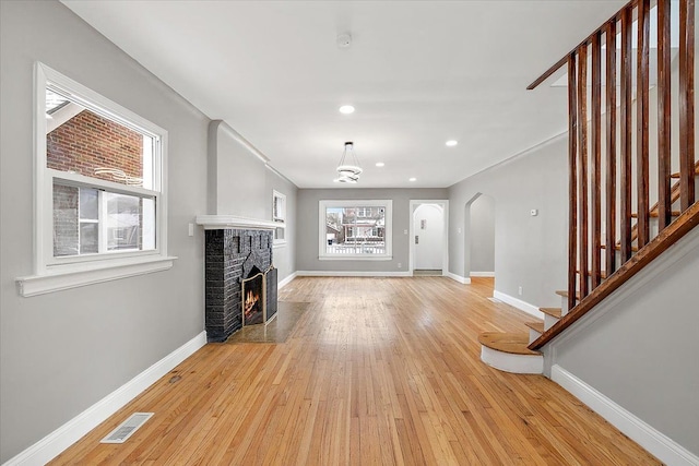 living room featuring light hardwood / wood-style floors and a brick fireplace