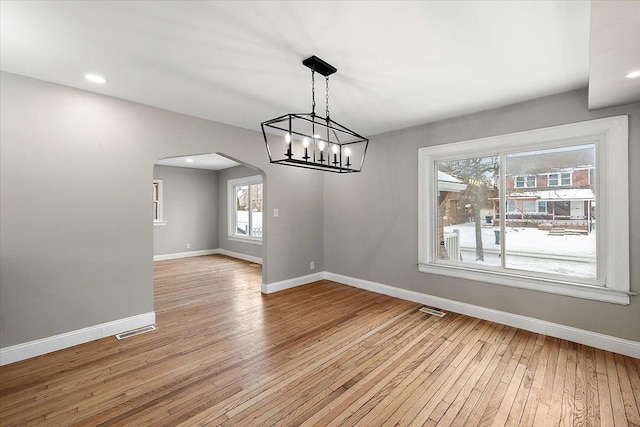 unfurnished dining area featuring plenty of natural light and light hardwood / wood-style floors