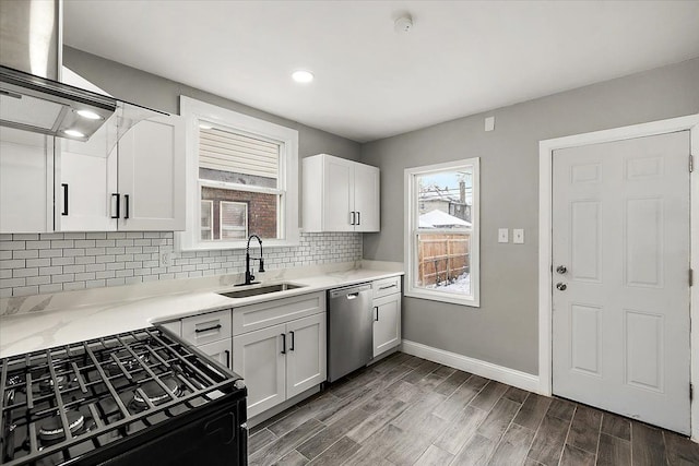 kitchen with dark wood-type flooring, sink, white cabinetry, stainless steel dishwasher, and black gas range