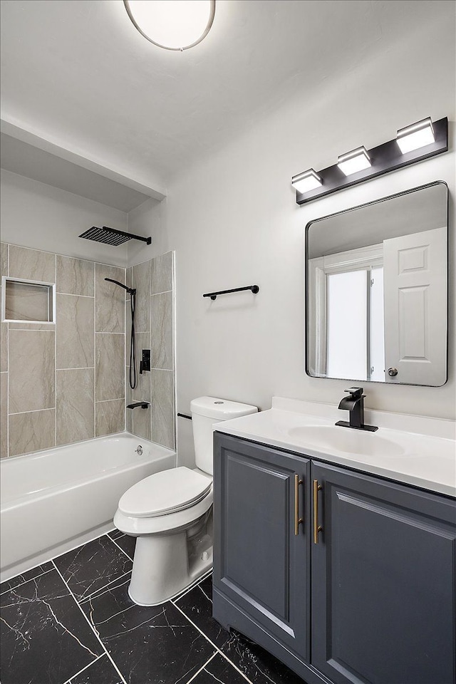 full bathroom featuring tiled shower / bath, vanity, and toilet