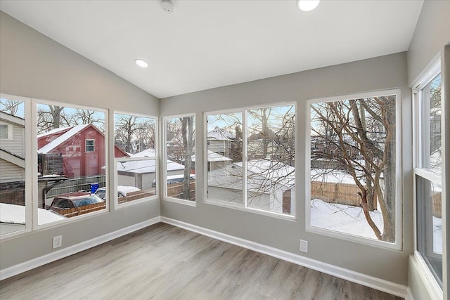 unfurnished sunroom featuring plenty of natural light and lofted ceiling