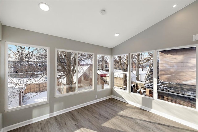 unfurnished sunroom featuring a healthy amount of sunlight and vaulted ceiling