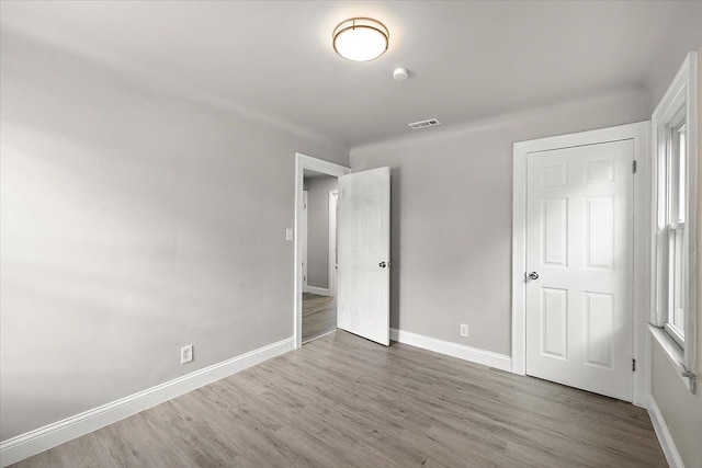 unfurnished bedroom featuring hardwood / wood-style flooring