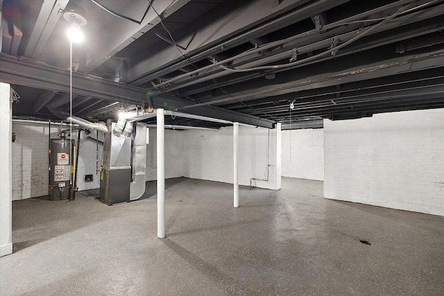 basement featuring heating unit and water heater