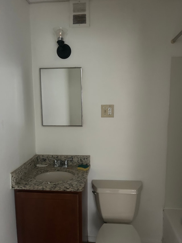 bathroom featuring vanity and toilet