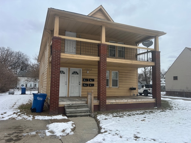 front of property featuring a balcony and covered porch