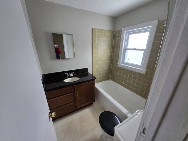 full bathroom with tiled shower / bath combo, vanity, and toilet