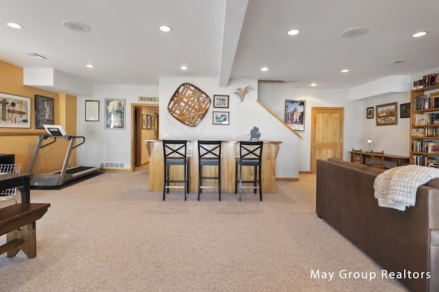 living room featuring beamed ceiling and light colored carpet