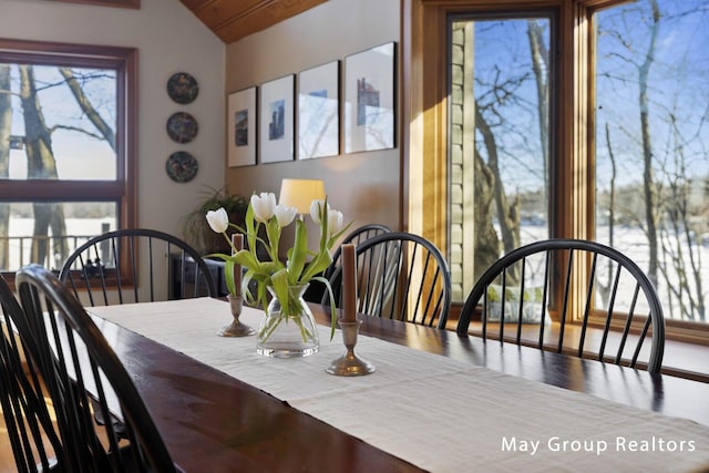 dining area featuring vaulted ceiling