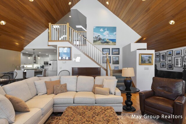 living room with wood ceiling and high vaulted ceiling