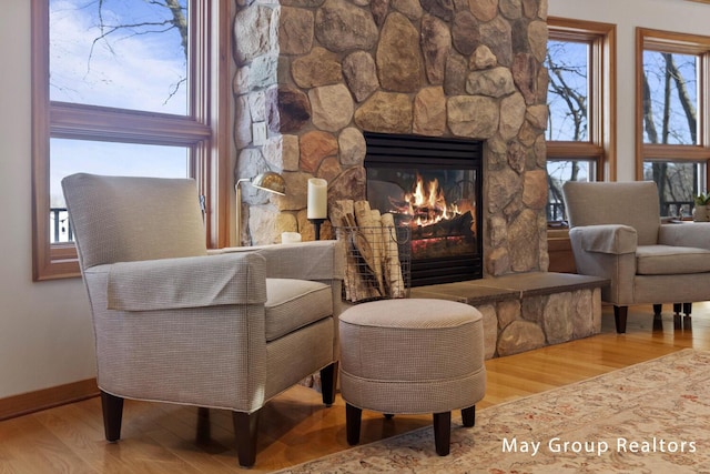 living area with hardwood / wood-style flooring and a fireplace