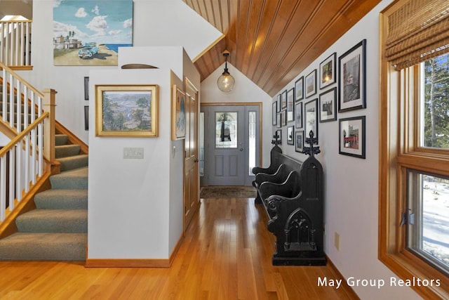 foyer featuring lofted ceiling, hardwood / wood-style floors, and wood ceiling