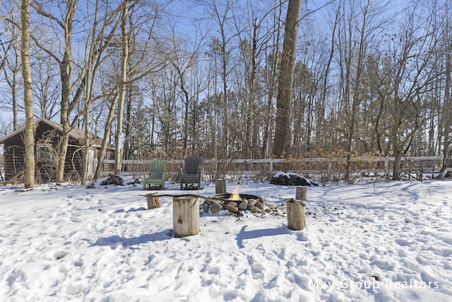 snowy yard featuring an outdoor fire pit