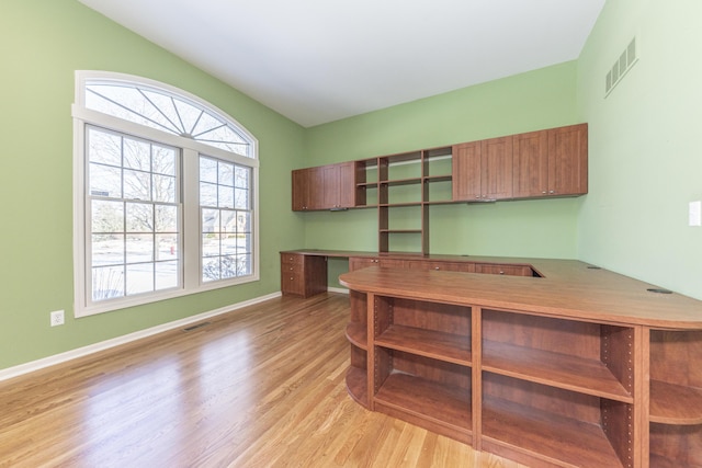 office space featuring built in desk and light hardwood / wood-style floors