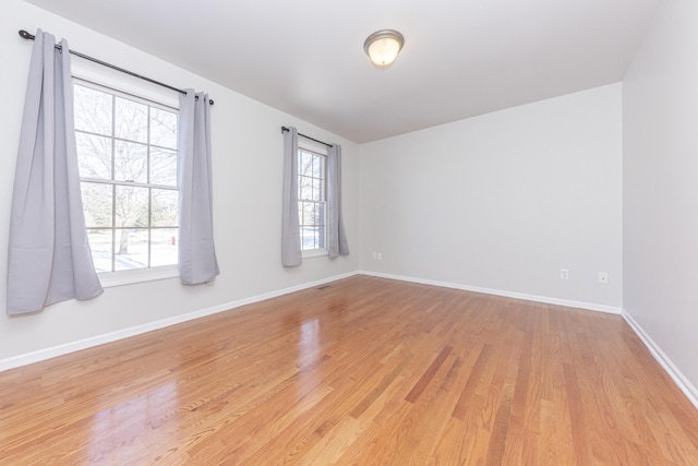 empty room with light hardwood / wood-style floors