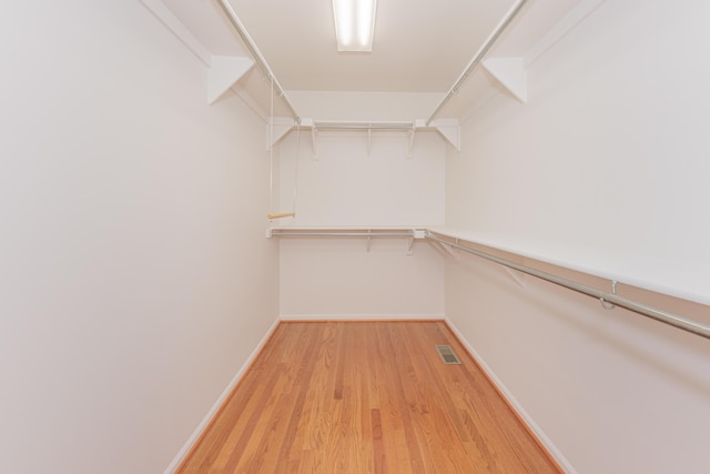 walk in closet featuring light hardwood / wood-style flooring