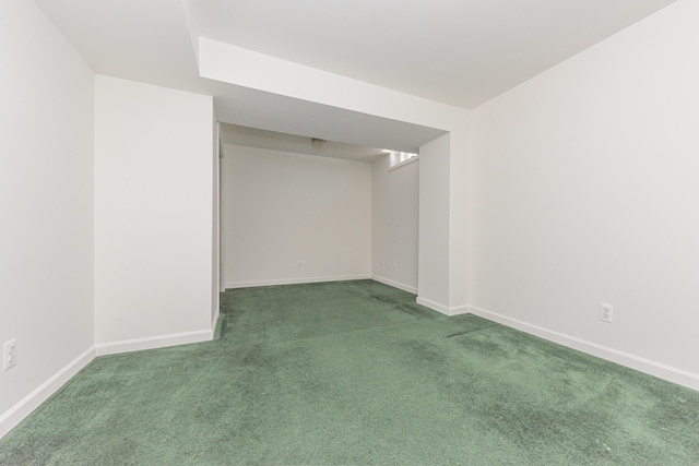 spare room featuring dark colored carpet