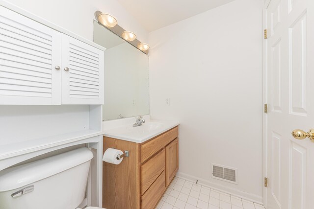 bathroom featuring vanity, toilet, and tile patterned flooring