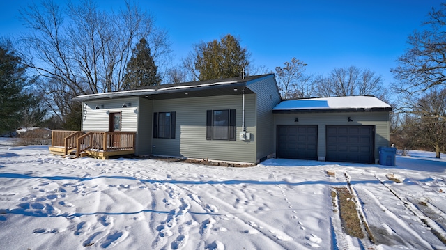 view of front of property featuring a garage and a deck