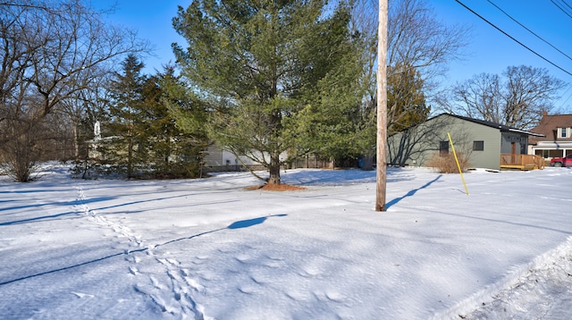 yard layered in snow with a wooden deck