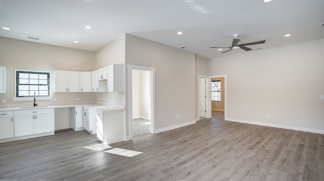 kitchen with white cabinetry, a wealth of natural light, light hardwood / wood-style floors, and ceiling fan