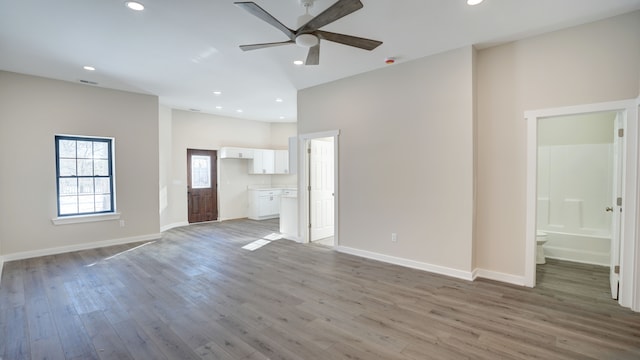 unfurnished living room featuring ceiling fan and light wood-type flooring