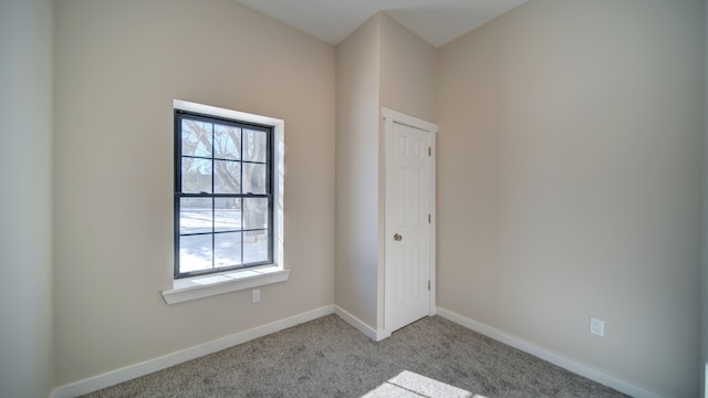 spare room with light colored carpet