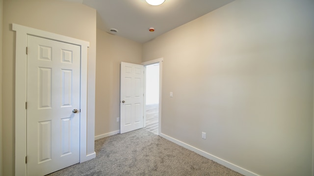 unfurnished bedroom with light colored carpet