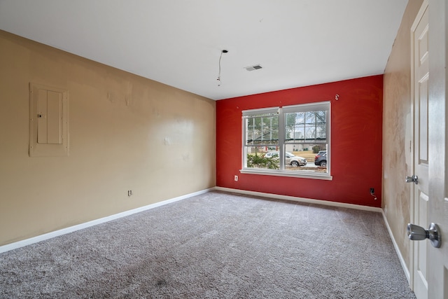 carpeted empty room with electric panel