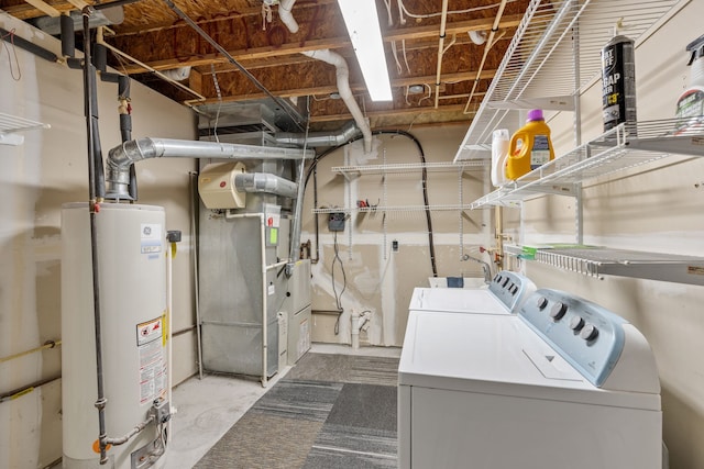 washroom with washer and clothes dryer, heating unit, and gas water heater