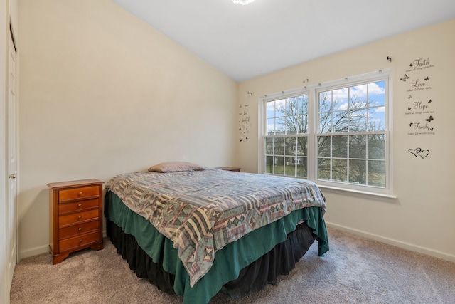 bedroom featuring light colored carpet and lofted ceiling