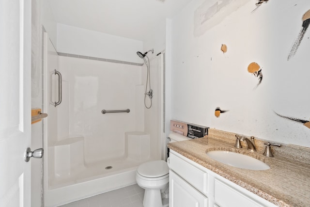 bathroom featuring tile patterned flooring, a shower, vanity, and toilet