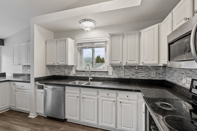 kitchen with tasteful backsplash, sink, white cabinets, stainless steel appliances, and dark wood-type flooring