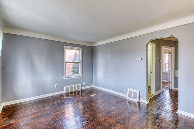 unfurnished room with plenty of natural light and dark hardwood / wood-style floors