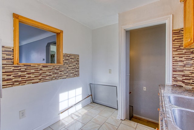 corridor with sink and light tile patterned floors