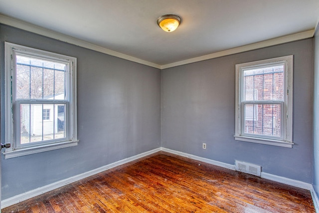 unfurnished room featuring crown molding and dark hardwood / wood-style flooring