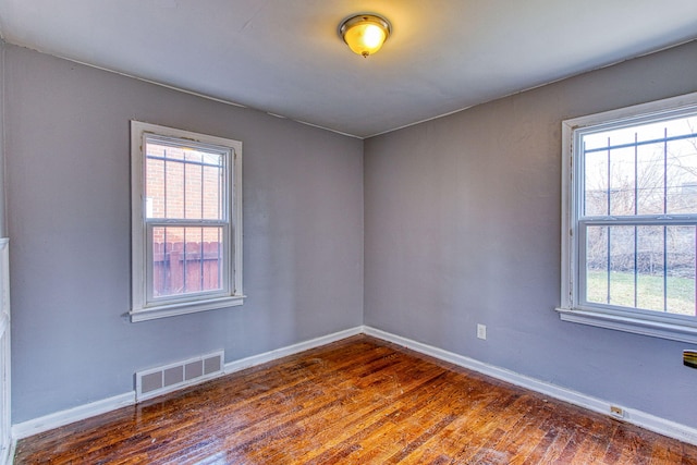 spare room with dark hardwood / wood-style floors