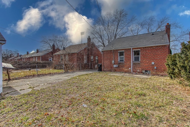 rear view of house with a lawn