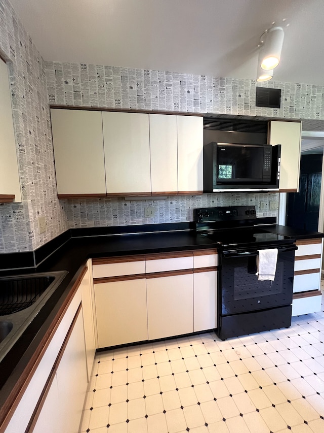 kitchen with white cabinetry and black appliances