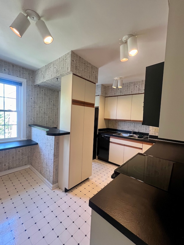 kitchen with sink, decorative backsplash, black dishwasher, and ceiling fan