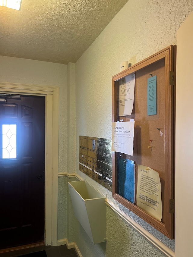 foyer entrance with a textured ceiling