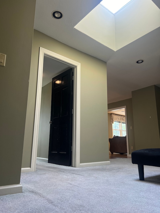 hallway featuring light colored carpet