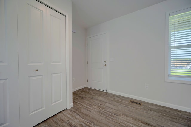 unfurnished bedroom with light wood-type flooring