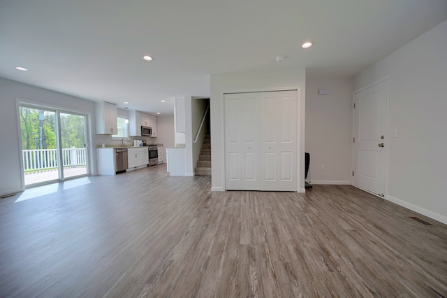 unfurnished living room with light wood-type flooring