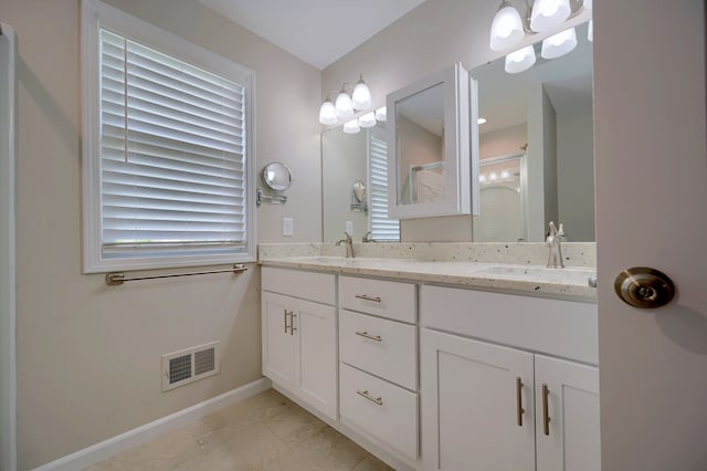 bathroom featuring walk in shower and vanity